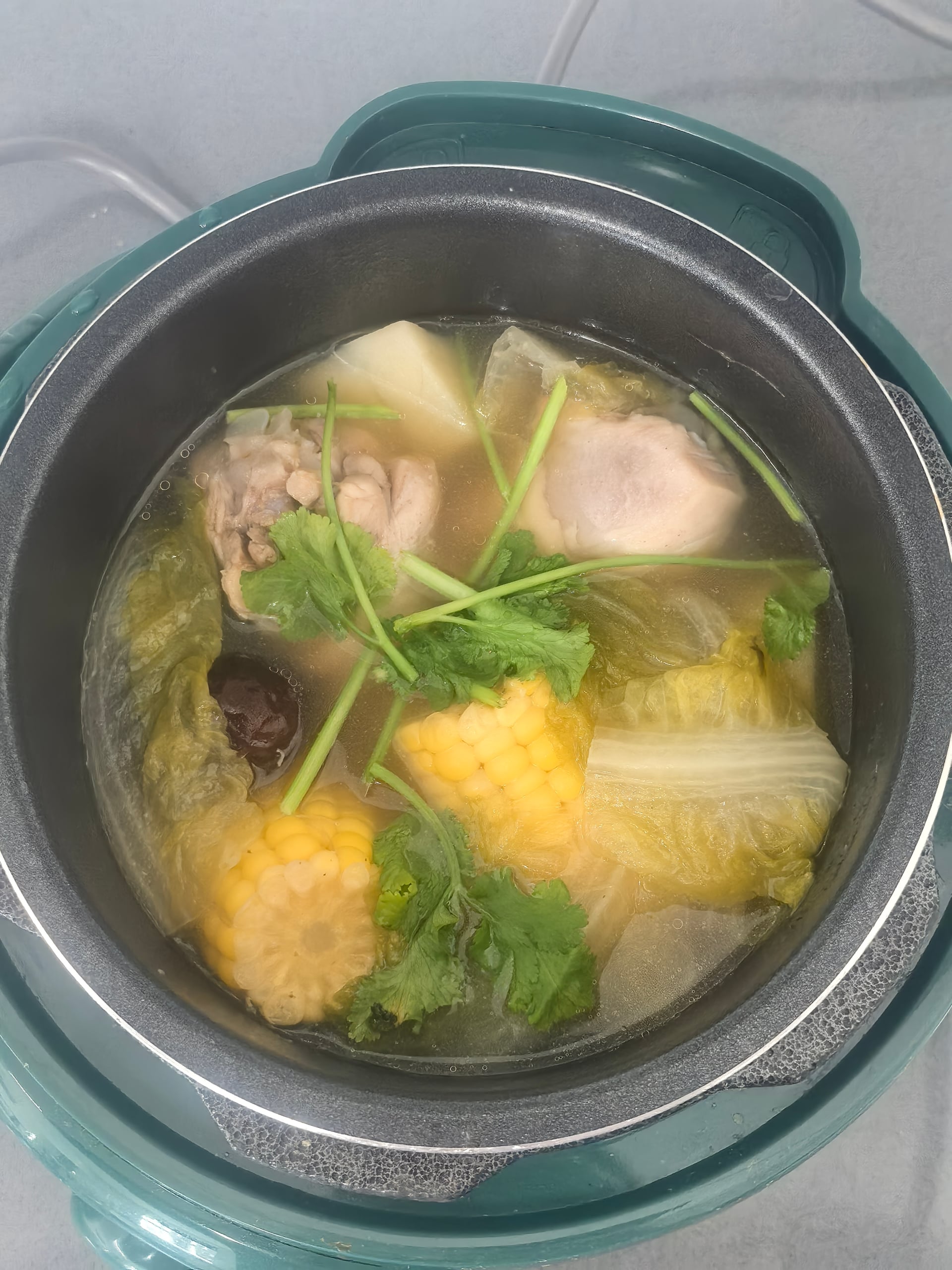 Home cooking — Corn and chicken soup simmering